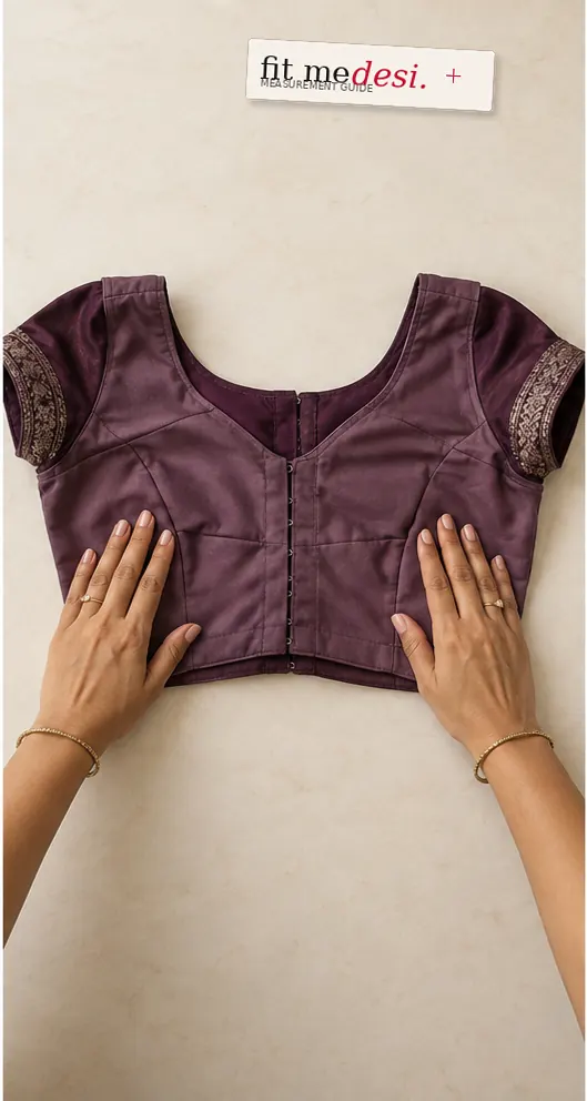 Hands fastening and smoothing an inside-out blouse flat