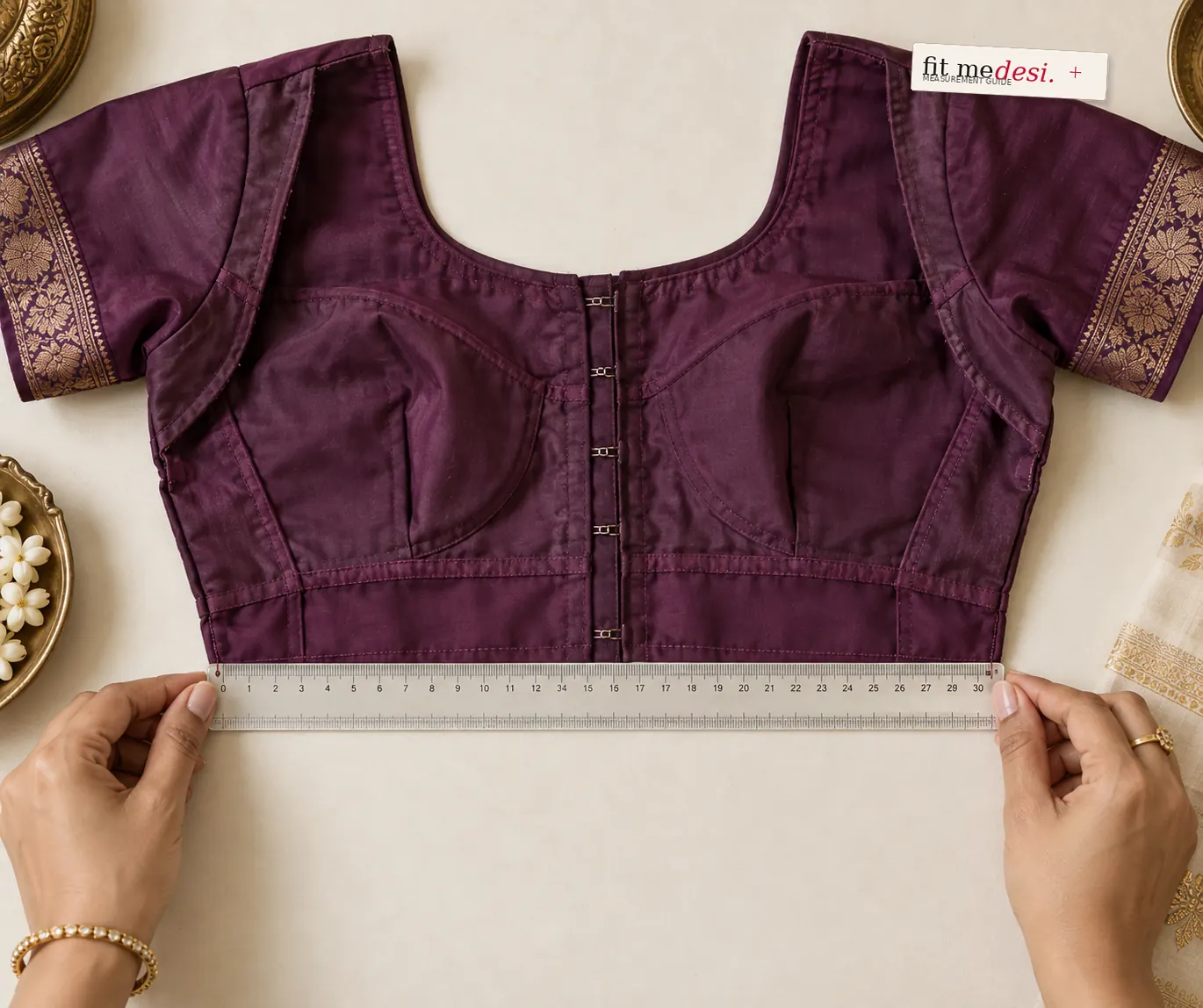 Hands measuring an inside-out blouse with a straight scale ruler