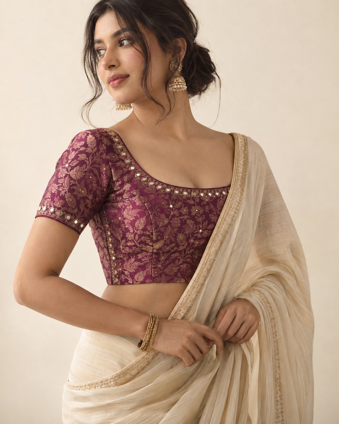 Plum brocade blouse styled with an ivory sari
