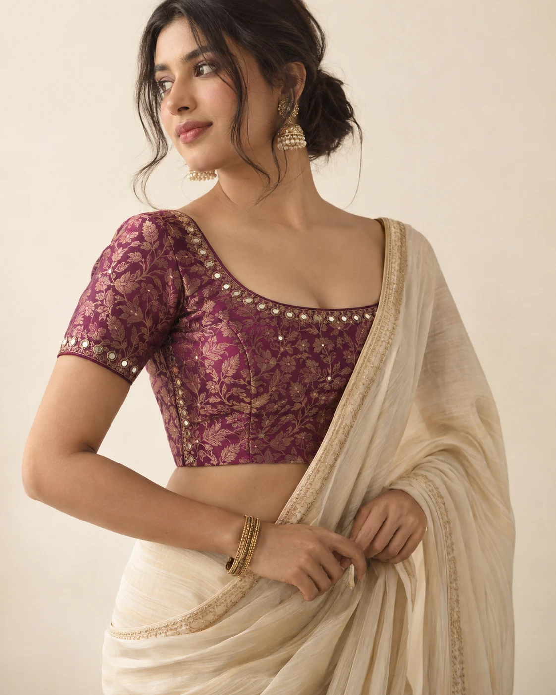 Plum brocade blouse with an ivory sari